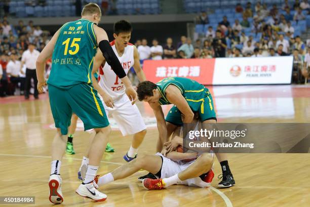 Rhys Martin of Australia fight the ball with Zhou Peng of China during the 2014 Sino-Australia Men's International Basketball Challenge match between...