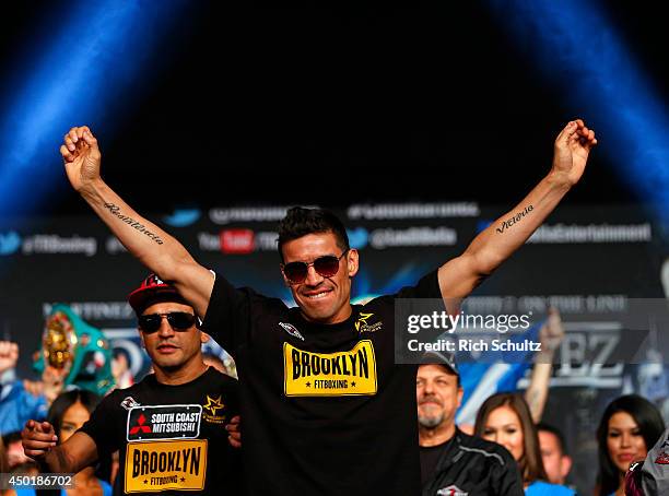 Sergio Martinez raises his arms before being weighed in on June 6, 2014 in New York City. Martinez will be fighting Miguel Cotto for the WBC...