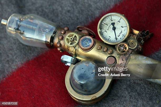 Steampunk modified Handpresso hand-powered espresso machine lies on a blanket during a Victorian picnic during the annual Wave-Gotik-Treffen music...