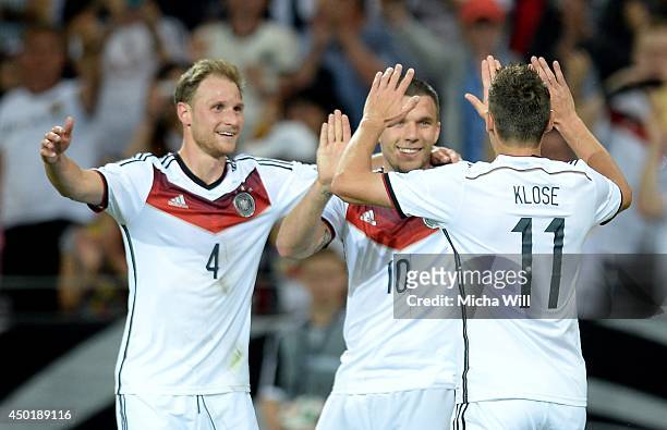 Miroslav Klose of Germany celebrates with team-mates after scoring his team's fourth goal during the international friendly match between Germany and...