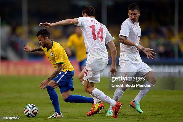 Daniel Alves of Brazil and Matic of Serbia compete for the ball during the International Friendly Match between Brazil and Serbia at Morumbi Stadium...