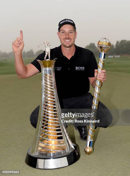 Henrik Stenson of Sweden celebrates with the Race to Dubai and the DP World Championship trophies after the final round of the 2013 DP World...