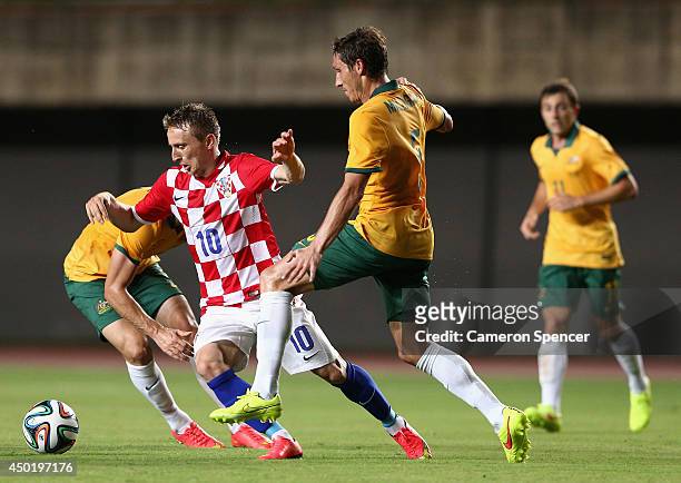 Luka Modric of Croatia is tackled by Mark Milligan of the Socceroos during the International Friendly match between Croatia and the Australian...