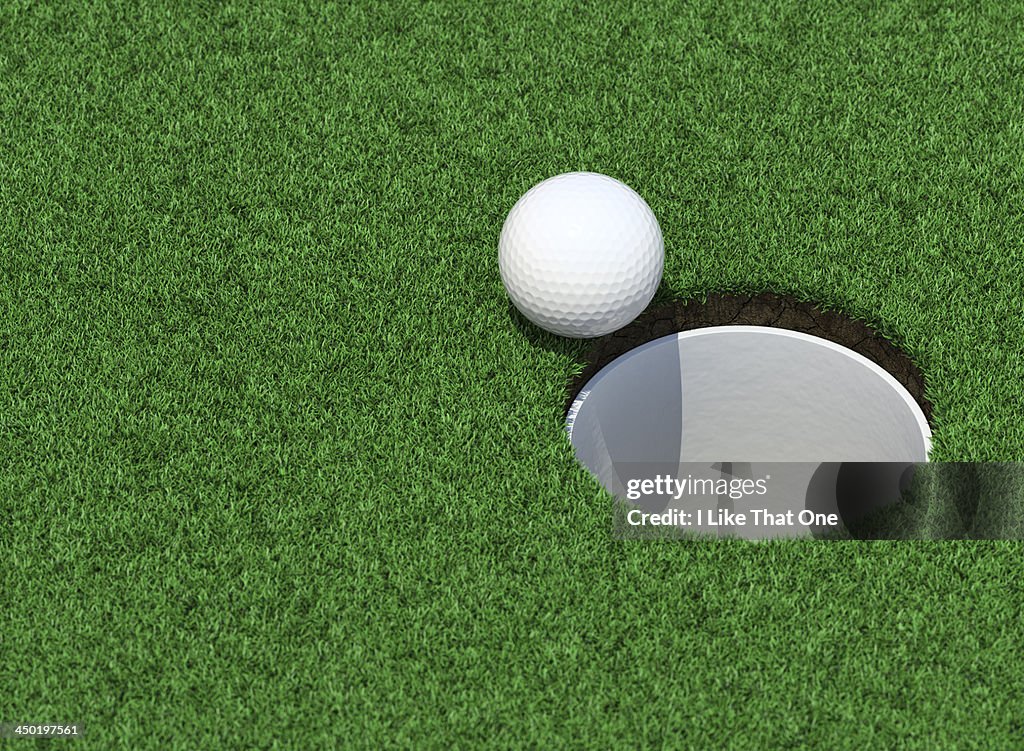 Golfball on the lip of the cup / golf hole