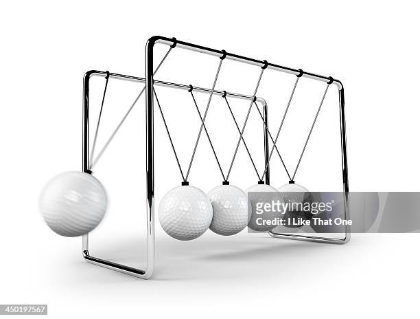 newtons cradle with golfballs swinging - newtons cradle stock pictures, royalty-free photos & images