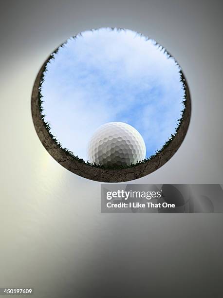 golfball on the lip of the cup / golf hole - golf ball hole stock pictures, royalty-free photos & images