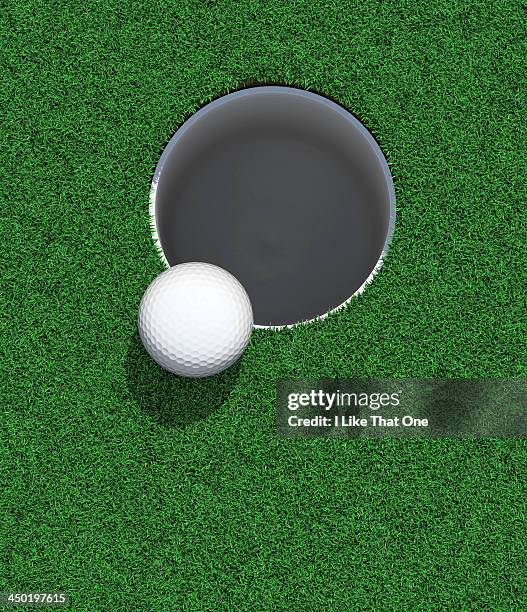 golfball on the lip of the cup / hole - the hole imagens e fotografias de stock