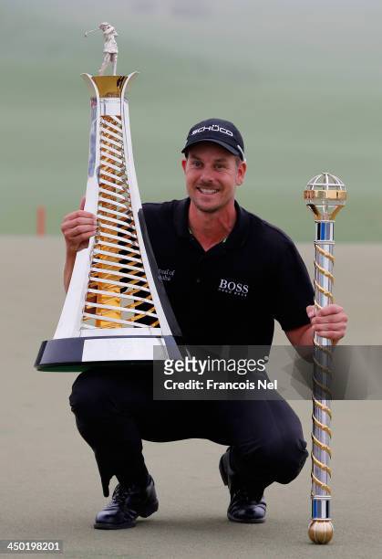 Henrik Stenson of Sweden poses with the Race To Dubai trophy and the DP World Tour Championship trophy after winning the DP World Tour Championship...