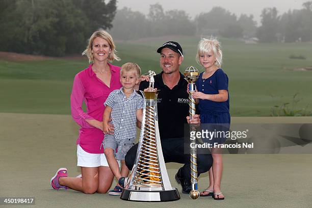 Henrik Stenson of Sweden, his wife Emma, son Karl and daughter Lisa celebrate with the Race to Dubai and the DP World Championship trophies after the...