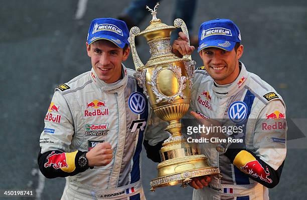 Sébastien Ogier and Julien Ingrassia of France and Volkswagen Motorsport pose with the winners trophy on the podium after the Great Orme stage of the...