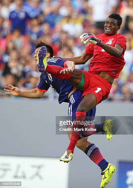 Shinji Okazaki of Japan collides with Toaster Nsabata of Zambia during the International Friendly Match between Japan and Zambia at Raymond James...