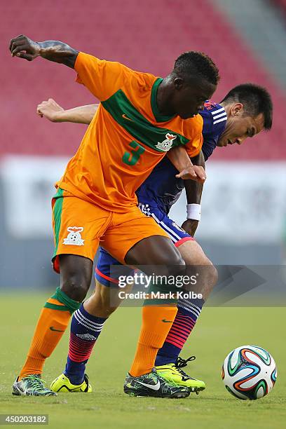 Shinji Okazaki of Japan and Chisamba Lungu of Zambia compete for the ball during the International Friendly Match between Japan and Zambia at Raymond...