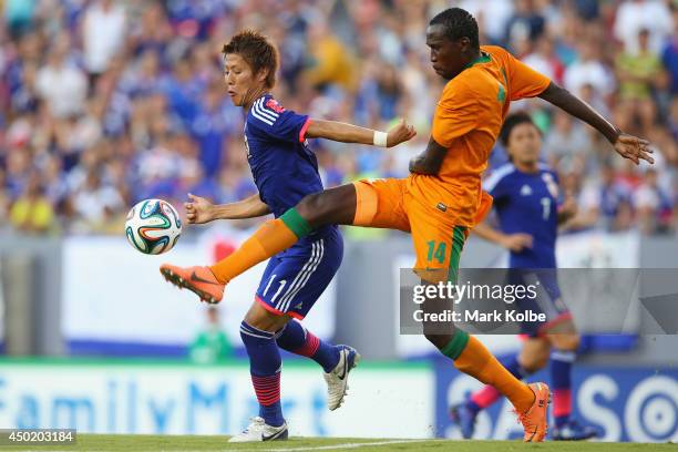 Kondwani Mtonga of Zambia clears the ball under pressure from Yoichiro Kakitani of Japan during the International Friendly Match between Japan and...