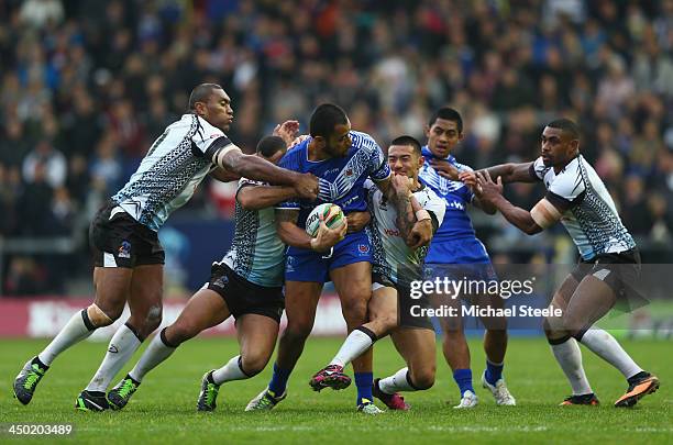 Tony Puletua of Samoa is crowded out in the tackle during the Rugby League World Cup Quarter Final match between Samoa and Fiji at The Halliwell...