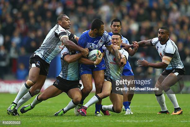 Tony Puletua of Samoa is crowded out in the tackle during the Rugby League World Cup Quarter Final match between Samoa and Fiji at The Halliwell...