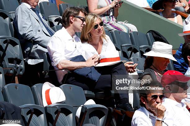 Politician Francois Baroin and actress Michele Laroque attend the Roland Garros French Tennis Open 2014 - Day 13 on June 6, 2014 in Paris, France.