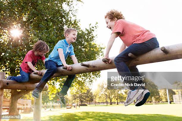 boys playing in the park - playground stock pictures, royalty-free photos & images
