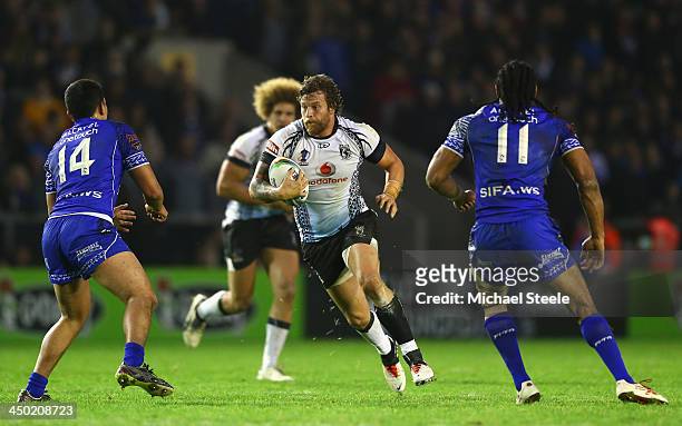 Ashton Sims of Fiji runs at Michael Sio and Iosia Soliola of Samoa during the Rugby League World Cup Quarter Final match between Samoa and Fiji at...