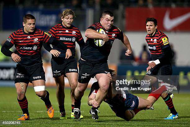 Matt Stevens of Saracens crashes through the tackle of Dan Thomas of Scarlets during the LV= Cup match between Saracens and Scarlets at Allianz Park...