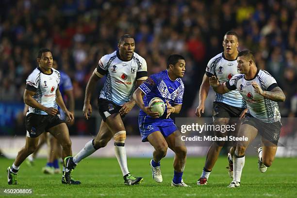 Anthony Milford of Samoa looks for a gap as Tariq Sims of Fiji closes in during the Rugby League World Cup Quarter Final match between Samoa and Fiji...