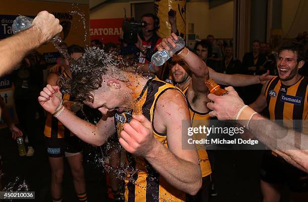 Luke Lowden of the Hawks gets doused with water as he celebrates his debut game with a win during the round 12 AFL match between the Hawthorn Hawks...