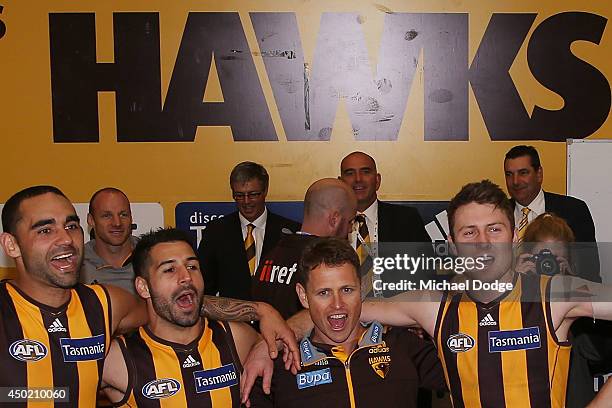 Stand-in Hawks coach Brendon Bolton sings the song with Shaun Burgoyne Paul Puopolo and Liam Shiels during the round 12 AFL match between the...