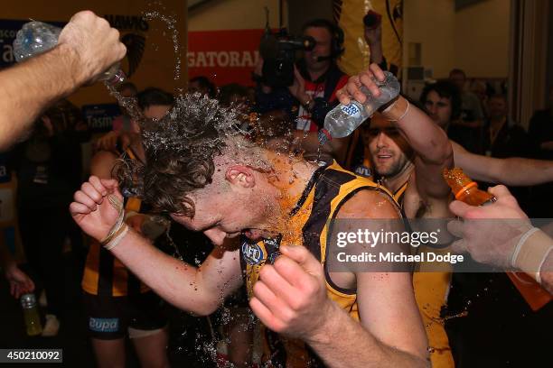 Luke Lowden of the Hawks gets doused with water as he celebrates his debut game with a win during the round 12 AFL match between the Hawthorn Hawks...