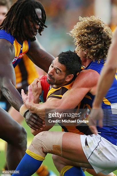 Paul Puopolo of the Hawks is tackled high by Matt Priddis of the Eagles during the round 12 AFL match between the Hawthorn Hawks and the West Coast...