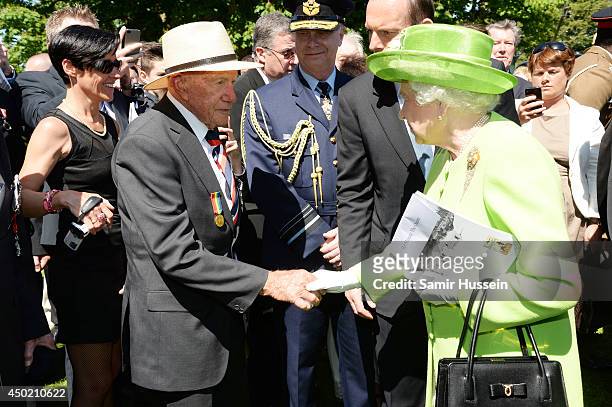 Queen Elizabeth II meets war veterans at Bayeux Cemetary during D-Day 70 Commemorations on June 6, 2014 in Bayeux, France.