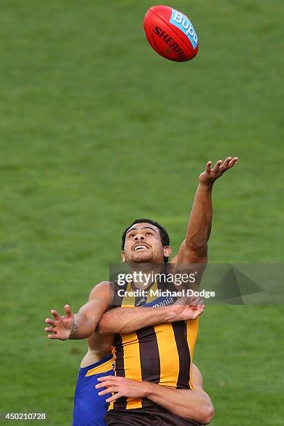 Cyril Rioli of the Hawks taps the ball on during the round 12 AFL match between the Hawthorn Hawks and the West Coast Eagles at Aurora Stadium on...