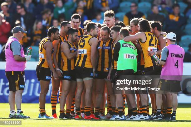 Luke Hodge of the Hawks talks to the players in a huddle during the round 12 AFL match between the Hawthorn Hawks and the West Coast Eagles at Aurora...