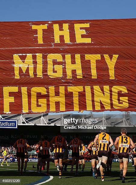 Hawks players runs through the banner during the round 12 AFL match between the Hawthorn Hawks and the West Coast Eagles at Aurora Stadium on June 7,...