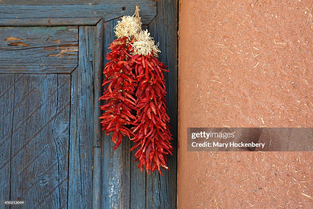 Truchas, NM chile ristras against adobe