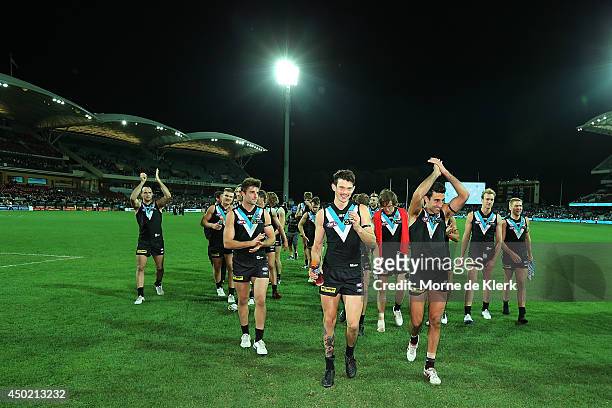 Power players celebrate after the round 12 AFL match between the Port Adelaide Power and the St Kilda Saints at Adelaide Oval on June 7, 2014 in...