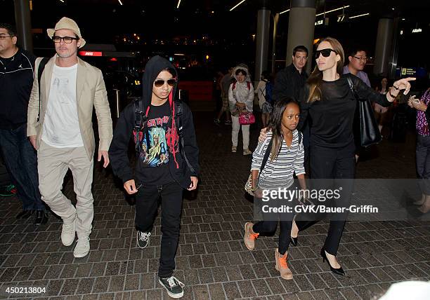 Brad Pitt, Maddox Jolie-Pitt, Zahara Jolie-Pitt and Angelina Jolie are seen at LAX on June 06, 2014 in Los Angeles, California.
