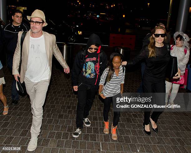 Brad Pitt, Maddox Jolie-Pitt, Zahara Jolie-Pitt and Angelina Jolie are seen at LAX on June 06, 2014 in Los Angeles, California.