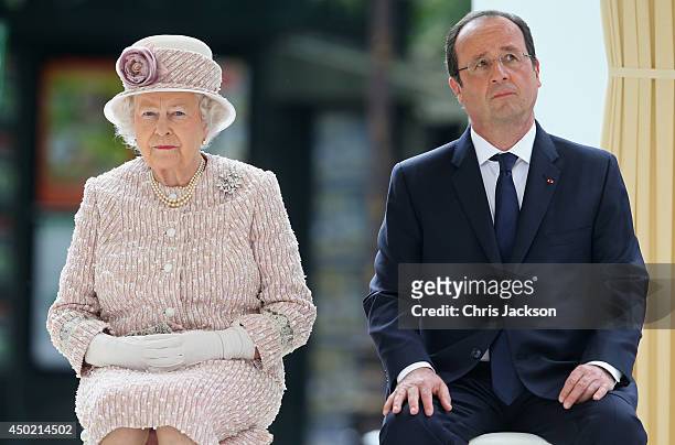 Queen Elizabeth II sits next to President of France Francois Hollande as they visit Paris Flower Market on June 7, 2014 in Paris, France. Queen...