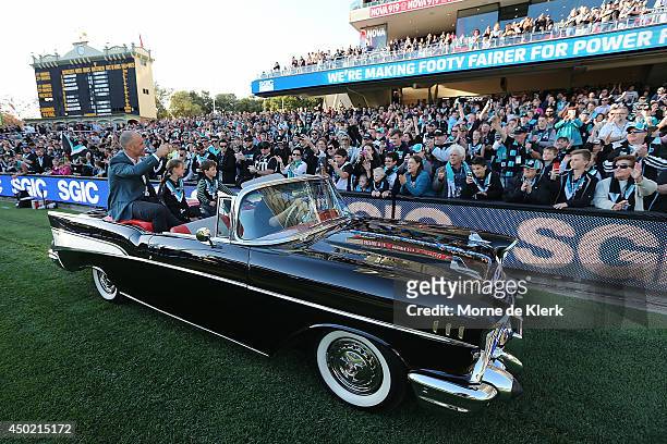 Former Power player Warren Tredrea completes a lap of honour around the Oval with his family before the round 12 AFL match between the Port Adelaide...