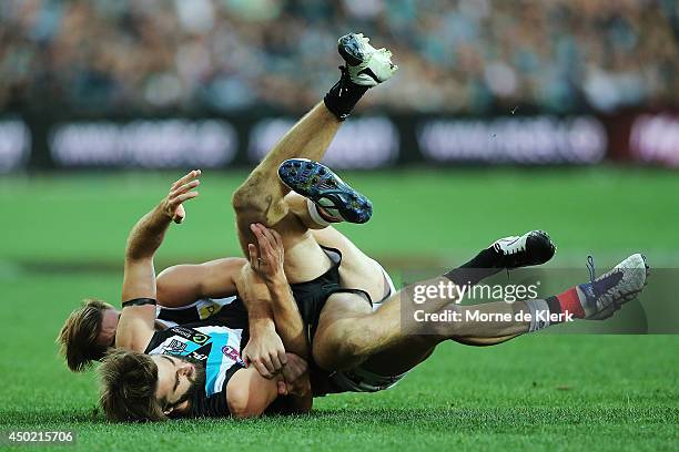 Justin Westhoff of the Power is tackled by Josh Bruce of the Saints during the round 12 AFL match between the Port Adelaide Power and the St Kilda...