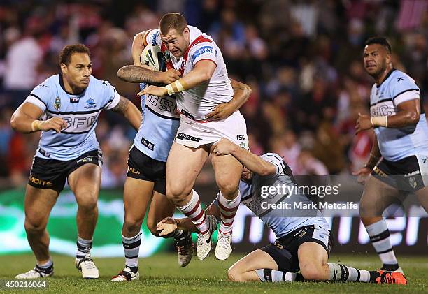 Trent Merrin of the Dragons is tackled during the round 13 NRL match between the St George Illawarra Dragons and the Cronulla-Sutherland Sharks at...