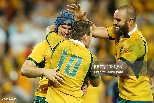 Pat McCabe of the Wallabies celebrates with Bernard Foley and Scott Fardy after scoring a try during the First International Test Match between the...