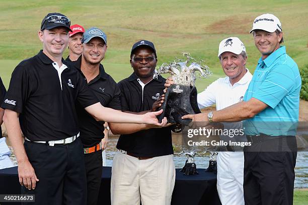 Anthony Leeming, Herschelle Gibbs, Mike Dladla, and professional golfer Retief Goosen of Team Goosen pose with Gary Player and the trophy during the...