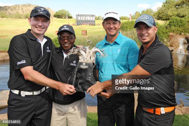 Anthony Leeming, Mike Dladla, professional golfer Retief Goosen and Herschelle Gibbs of Team Goosen pose with the trophy during the prizegiving...