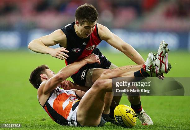 Zach Merrett of the Bombers competes for the ball against Stephen Coniglio of the Giants during the round 12 AFL match between the Greater Western...
