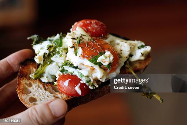 baked eggs with feta cheese - griekse gerechten stockfoto's en -beelden