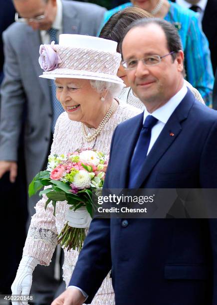 Britain's Queen Elizabeth II and French President Francois Hollande visit the newly renamed "Queen Elizabeth II" flower market on June 7 in Paris,...