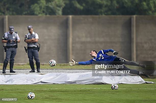 Bosnia and Herzegovina's goalkeeper Asmir Avdukic dives to stop a ball during a training session at the Antonio Fernandez Stadium in Guaruja on June...
