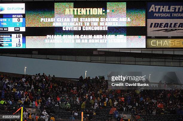 Fans evacuate the stadium because of weather after a game between the Chicago Bears and the Baltimore Ravens was delayed on November 17, 2013 at...