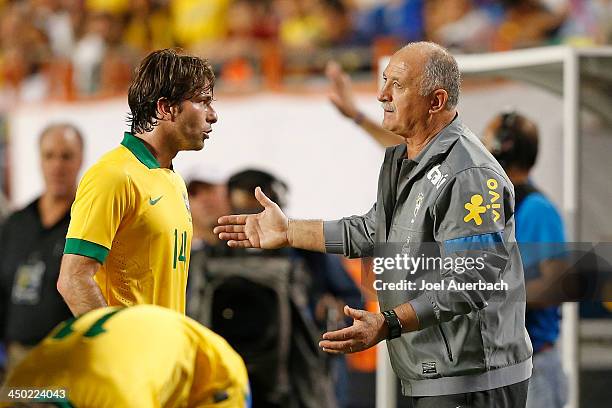 Manager Luiz Felipe Scolari talks to Maxwell of Brazil during a break in action against Honduras on November 16, 2013 during a friendly match at...
