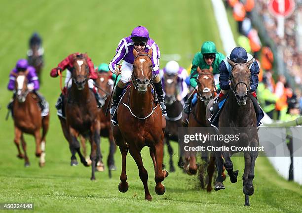 Joseph O'Brien riding Australia celebrates winning The Investec Derby at Epsom racecourse on June 07, 2014 in Epsom, England.